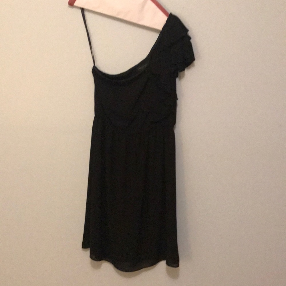 Black one shoulder dress.